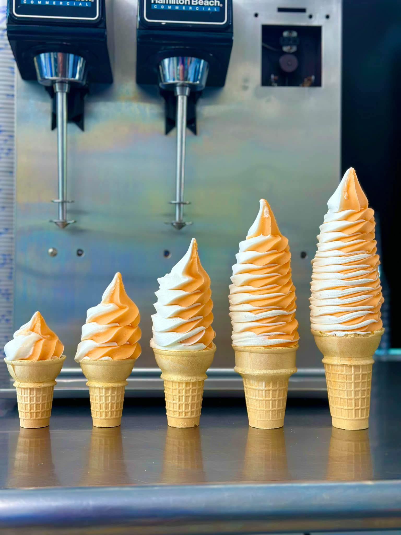 Five sizes of Dairy Haven’s homemade orange sherbert and vanilla twist cones lined up on the counter